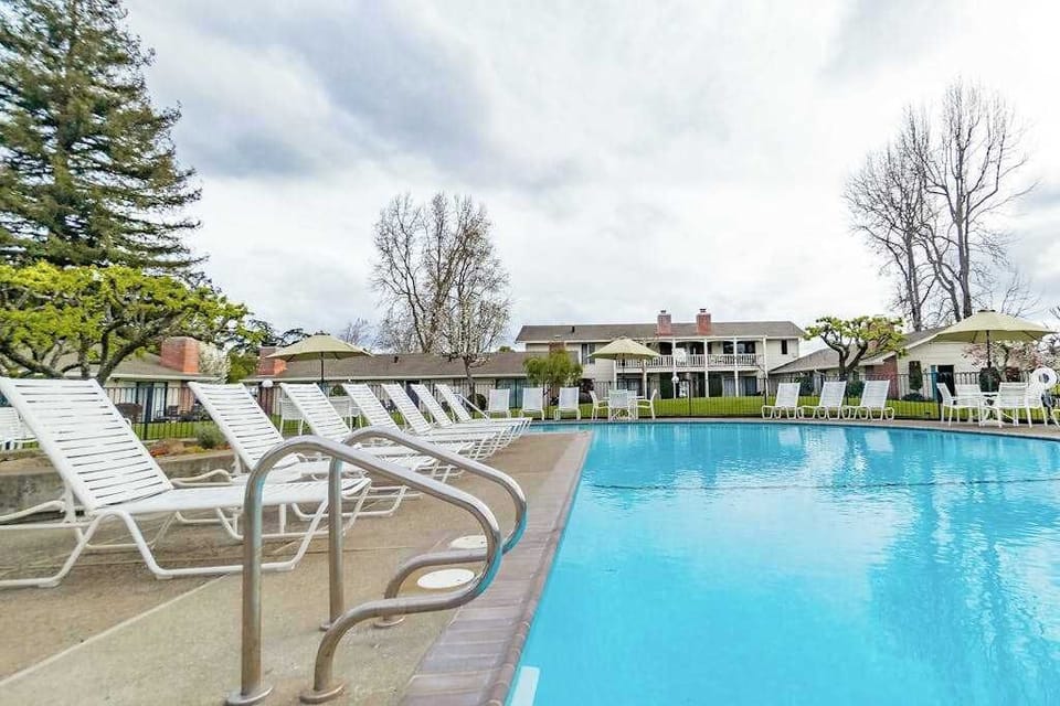 Dive into crystal-clear water surrounded by classic Napa Valley resort architecture — your poolside afternoon is calling.