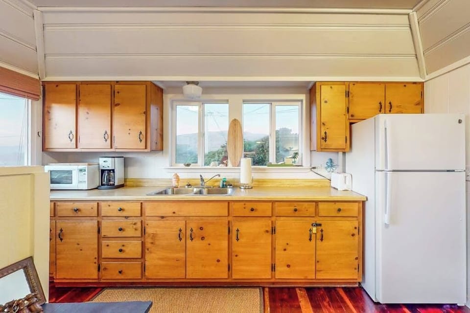 Brew your morning coffee with a view in this fully equipped Bodega Bay kitchen — warm wood cabinetry and everything you need to cook fresh Sonoma County fare.