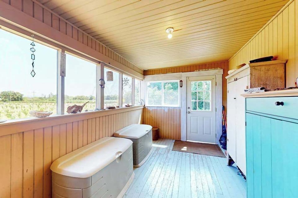 Step through your enclosed sunporch and catch sweeping countryside views — a bright, breezy transition between your Healdsburg cottage and the vineyard landscape.