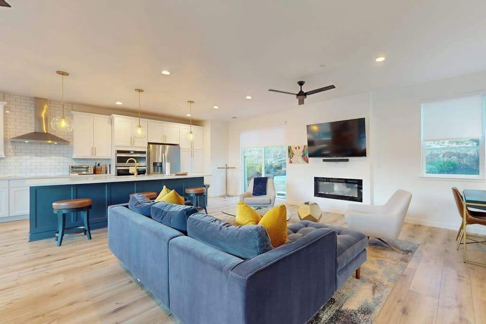 Gather your group around the gas fireplace in this open-concept great room — with a chef's kitchen, smart TV, and Sonoma hillside views all within reach.