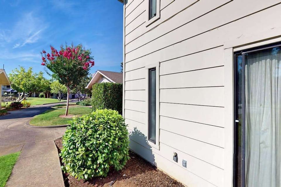 Blooming crape myrtles and sculpted hedges frame your private entrance at Silverado — Napa Valley curb appeal at its best