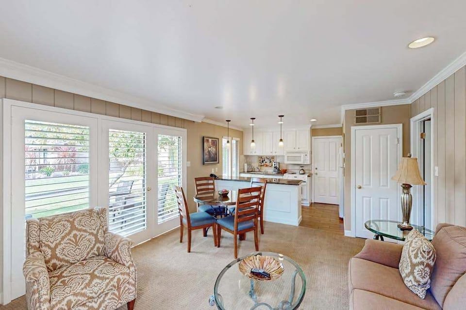Gather your group in the bright open-concept living and dining space with views of the resort grounds through oversized windows