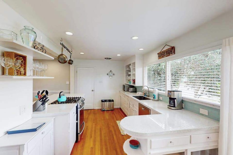 Brew your morning coffee and toast local sourdough in a bright galley kitchen stocked with everything you need — ample counter space lets you prep charcuterie for sunset on the patio.