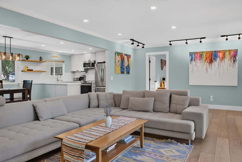 Open-plan living means whoever's cooking stays in the conversation while the rest of you spread out on the L-shaped couch.