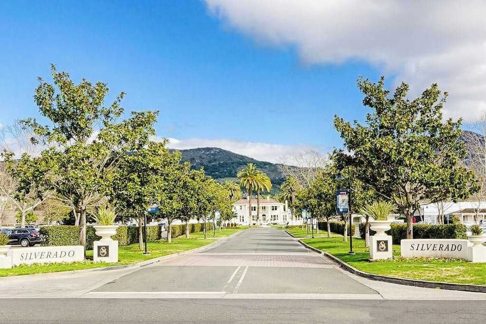 Drive through the iconic Silverado gates with mountain views ahead — your Napa Valley escape begins the moment you arrive at this storied resort.