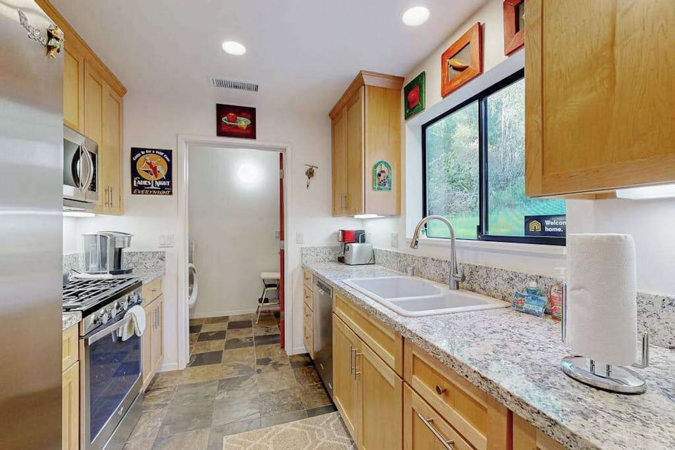 Prepare your favorite recipes in this fully equipped galley kitchen with granite countertops and stainless steel appliances.
