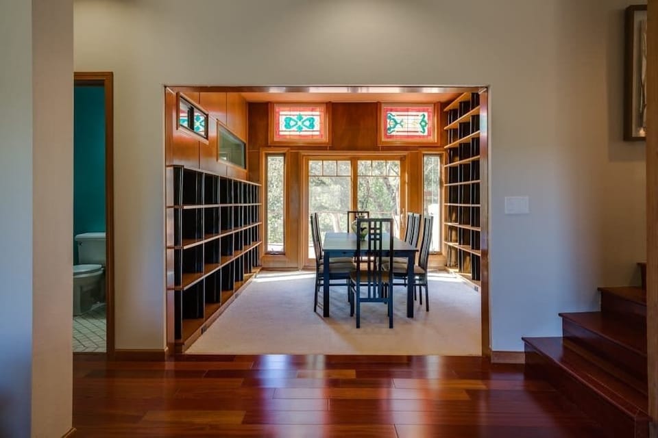 Browse the built-in library shelves, then linger over dinner beneath stained glass transoms — this is wine country dining at its most storied.