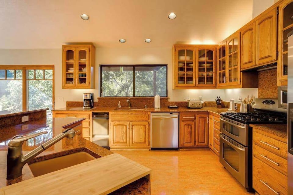 Channel your inner chef in this gourmet kitchen with stainless steel appliances, abundant cabinet space, and views of the surrounding canopy.