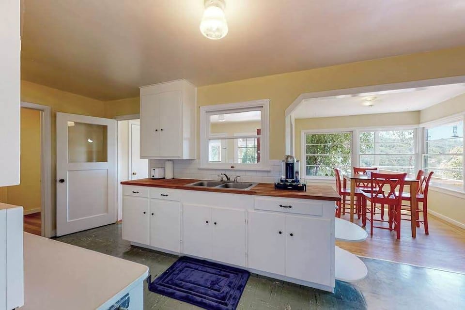 Brew your morning pour-over and gaze out at the Healdsburg hills — your open cottage kitchen flows right into the sunny dining area.