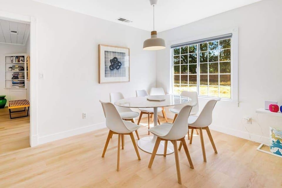 Linger over dinner for six at your Scandinavian-style dining table — garden views through the window and warm pendant light setting the Sonoma County mood.