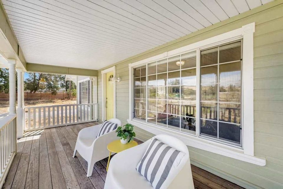 Morning coffee tastes better on your covered front porch — striped-pillow loungers face the Healdsburg countryside, inviting you to slow down and sip.