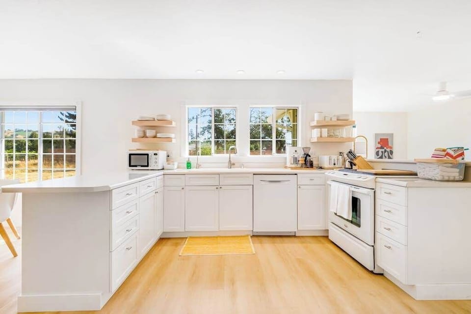 Spread out in your U-shaped farmhouse kitchen with open shelving, generous counters, and windows framing the Healdsburg countryside — every meal feels inspired.