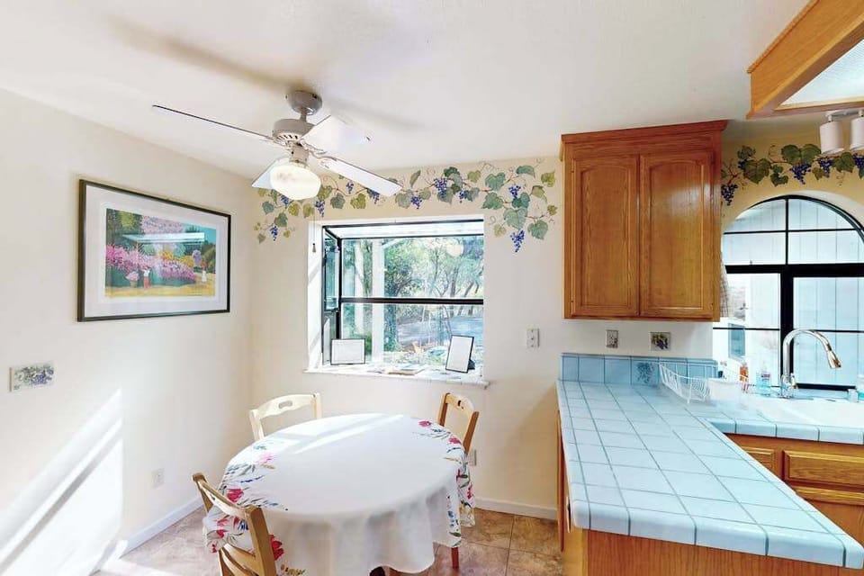 Sip your morning coffee at the charming breakfast nook, framed by hand-painted grapevine accents that echo the vineyards just minutes from your door.
