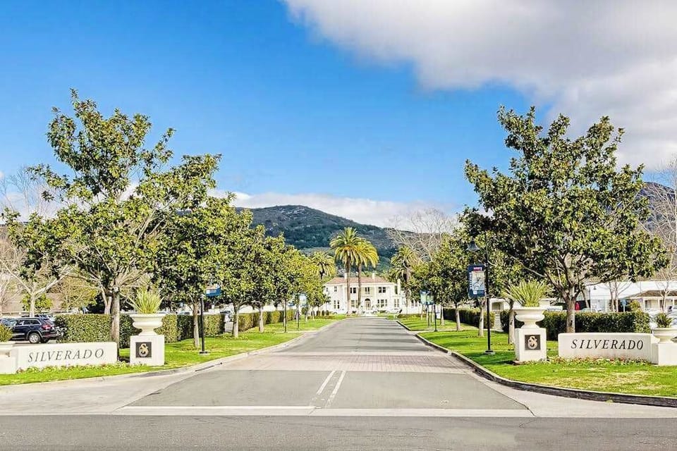 Welcome to Silverado Resort — your Napa Valley home base framed by a grand tree-lined drive and mountain backdrop