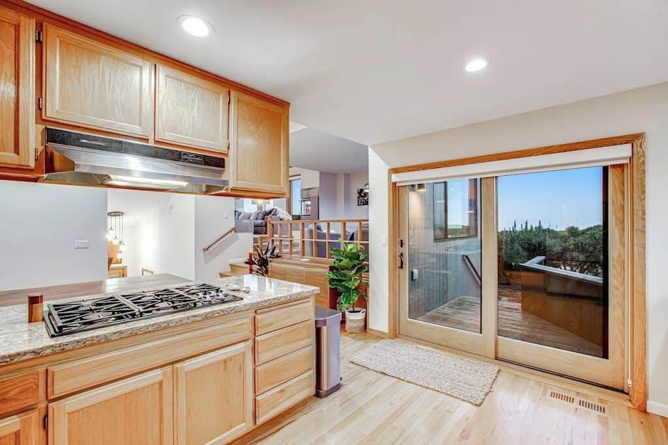 Step from your gas cooktop right onto the deck through sliding glass doors — perfect for grilling and entertaining on the Sonoma Coast