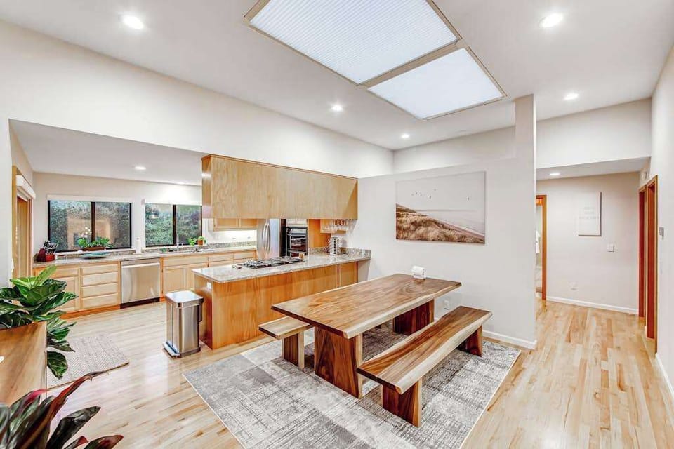 Bright skylights flood your kitchen with natural light — gather around the handcrafted live-edge bench table for farm-to-table meals together
