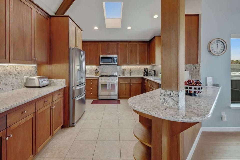 Skylights brighten your fully equipped chef's kitchen, complete with stainless steel range and generous counter space.