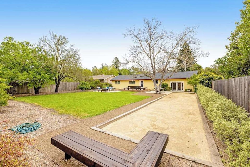 Roll a round of bocce with your travel partners — the full-length court, lush lawn, and picnic area turn your Kenwood backyard into a private resort.
