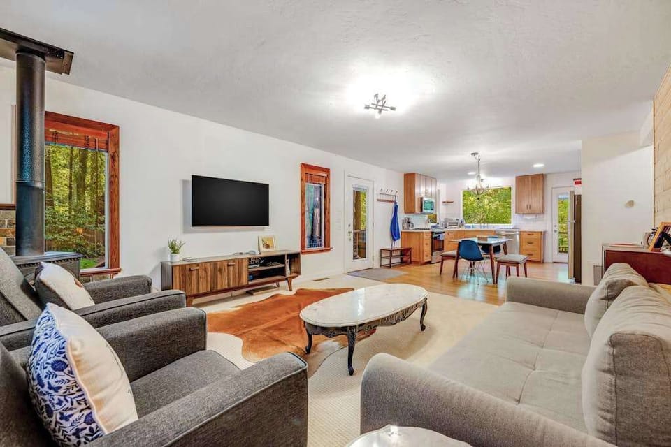 Stretch out in your open-concept living area with ample seating, a flat-screen TV, and a stylish cowhide rug — the kitchen is steps away for easy entertaining.