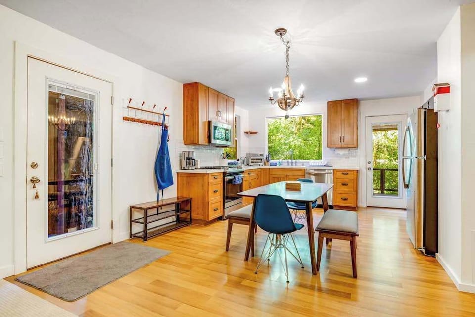 Gather around the dining table for a wine-country meal — your kitchen features warm wood cabinetry, a chandelier, and hooks by the door for your hiking gear.