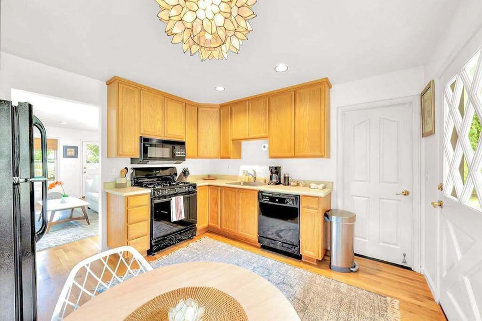 Your guest cottage kitchenette keeps everyone self-sufficient — a full stove, microwave, and coffee maker mean no one fights over the main kitchen