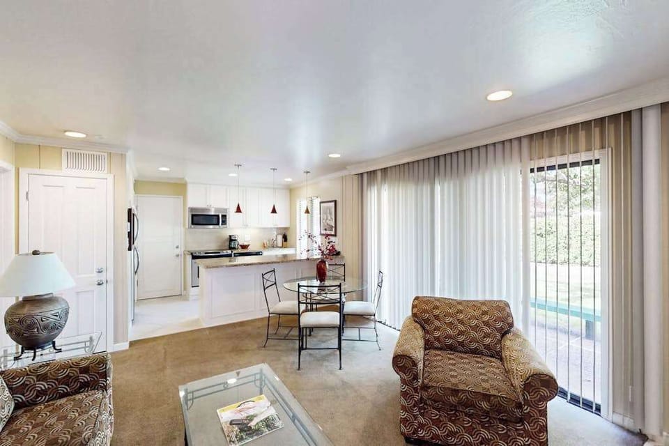 Take in the open layout connecting your living area to the kitchen — floor-to-ceiling windows fill the space with Napa sunshine while you plan your next wine country outing.