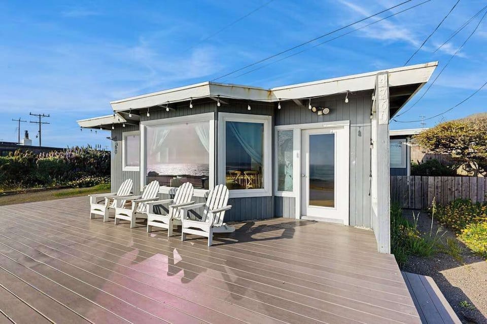 Relax on your private sun-drenched deck with Adirondack chairs and string lights at this Bodega Bay coastal retreat