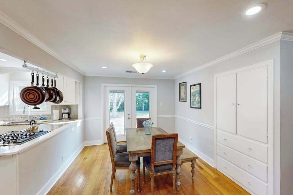 Share a farm-to-table meal at the wooden dining table with hanging copper pans overhead — your full kitchen is just steps away for easy wine country entertaining