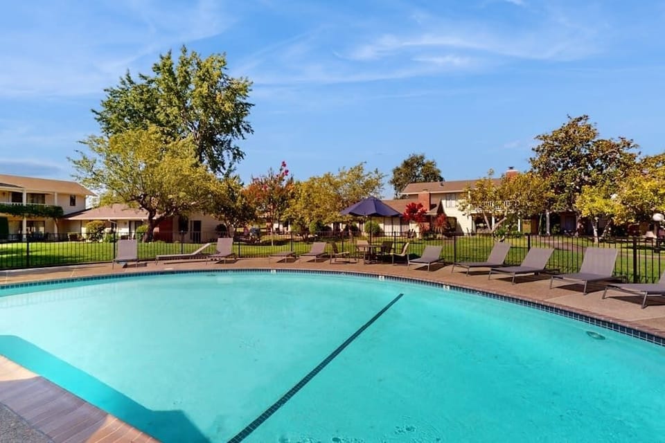 Dive into the sparkling communal pool surrounded by lounge chairs and Napa Valley sunshine — your afternoon bliss awaits