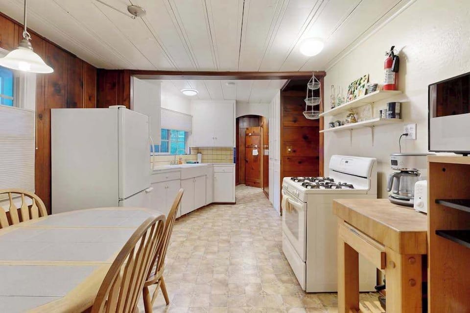 Prepare farm-to-table meals in your fully equipped kitchen with gas range, ample counter space, and open shelving.