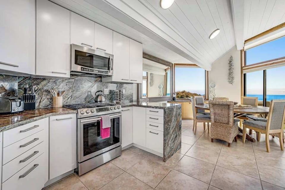 Cook while you gaze — your ocean-view kitchen opens to the dining room so the chef never misses the sunset over Bodega Head