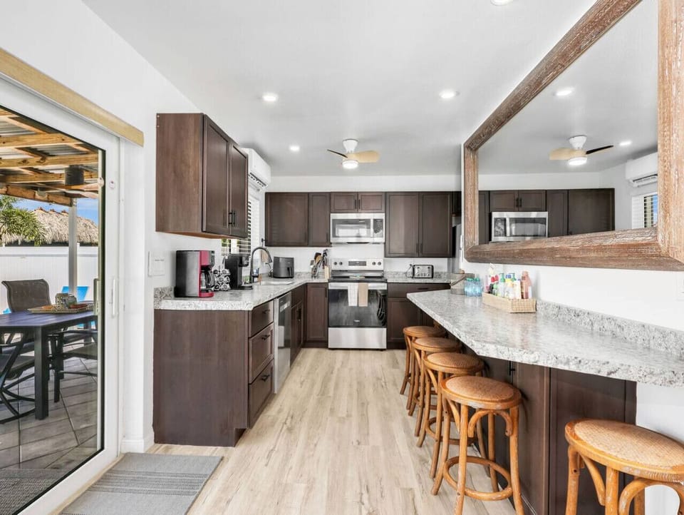 A spacious, well-stocked kitchen with plenty of counter space and seating—ideal for cooking and spending time together.