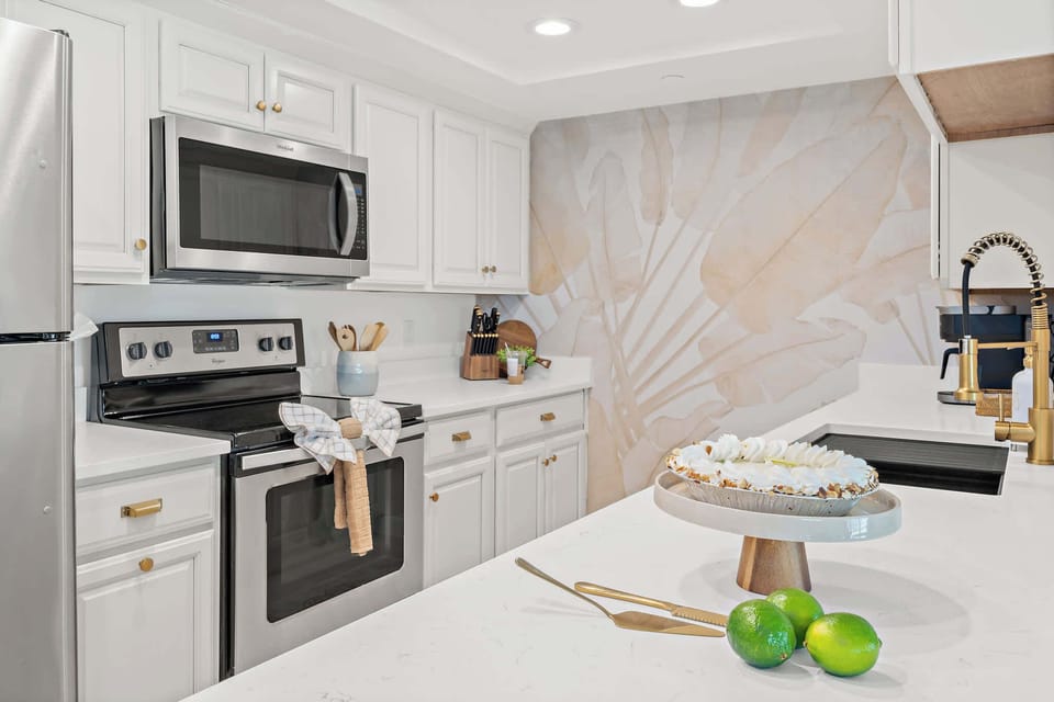 Kitchen counter with microwave, fruits, palm wallpaper
