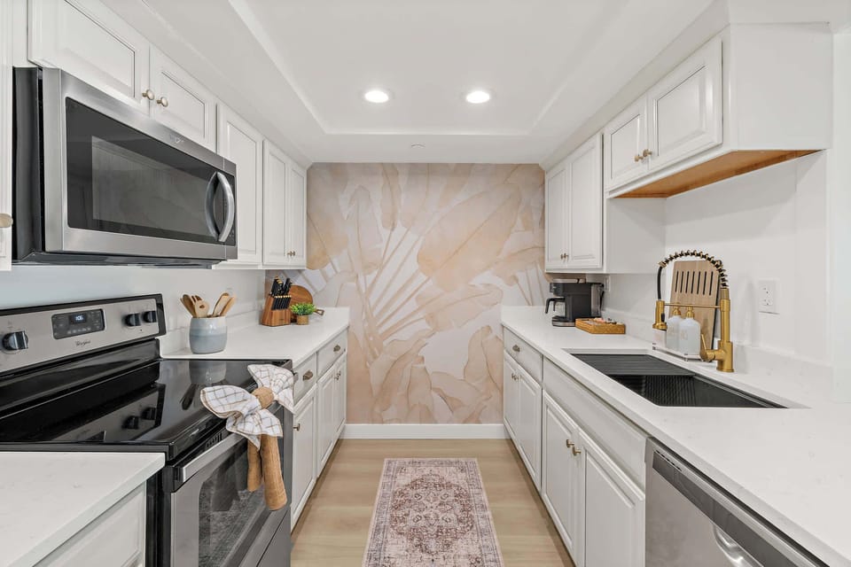 Full Kitchen with Stainless Appliances and Coastal Wallpaper