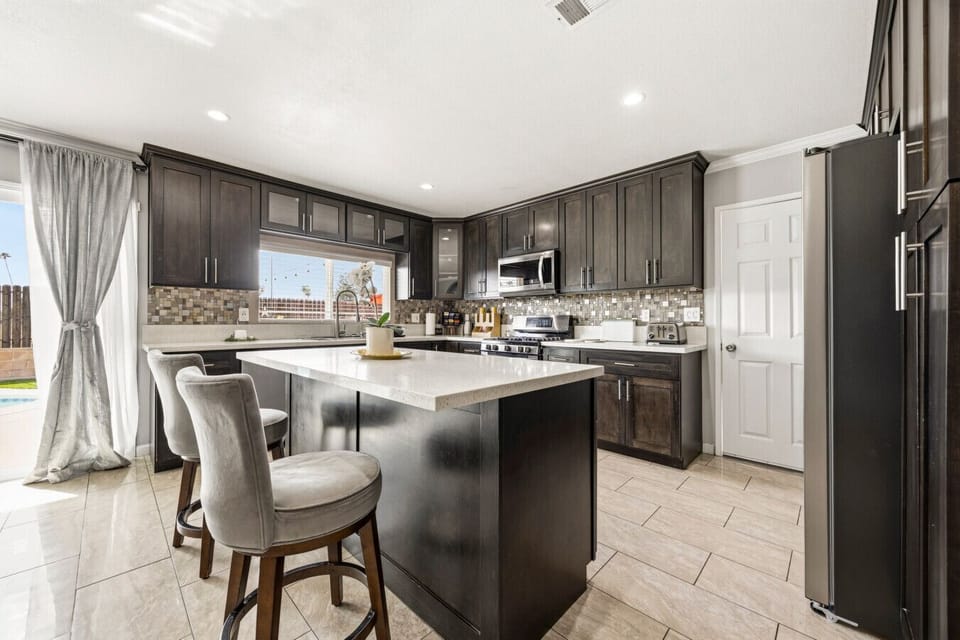The open-concept kitchen flows seamlessly, offering abundant natural light and direct access to the backyard.