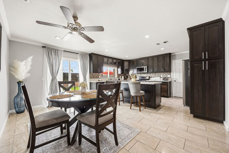 Gather around the elegant dining table, open to our fully equipped modern kitchen and spacious island.
