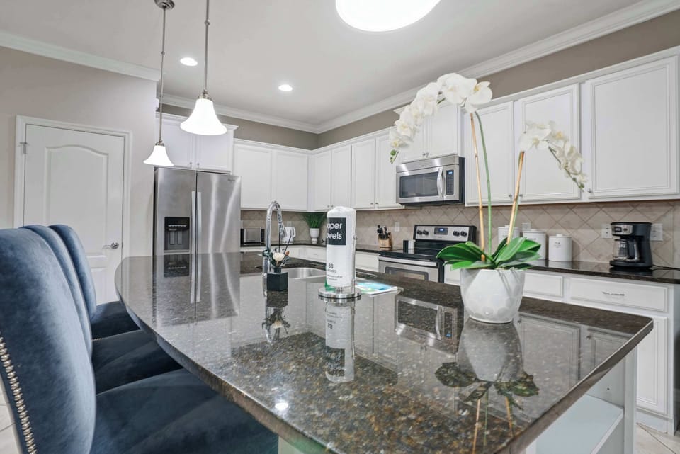 Modern kitchen with granite island and stainless steel appliances