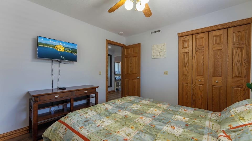 Another view of queen room with a smart tv