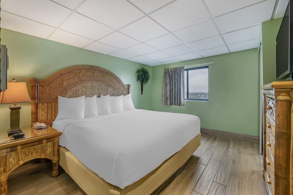 Unwind in a crisp king bed after beach days.