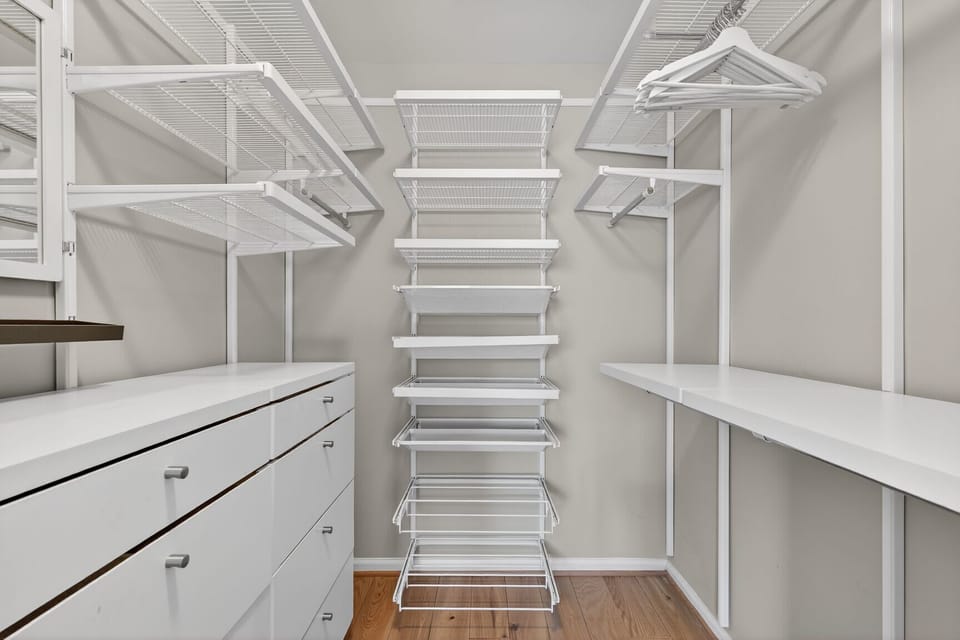 Custom-designed closet with vanity, drawers, jewelry, and shoe storage.