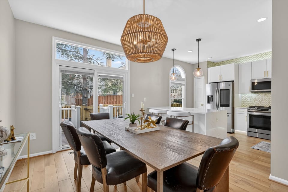 Architectural details shine in this dining room, featuring high ceilings and transom windows that bathe the space in natural light.