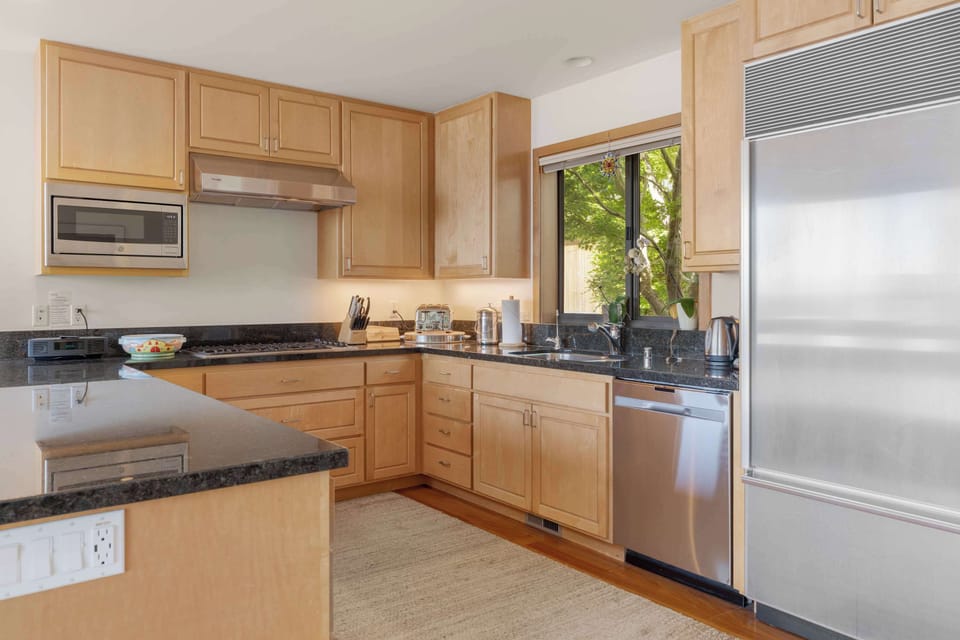 Sub-Zero fridge, dishwasher, and a garden window over the sink — load up at the Gualala or Sea Ranch Market and you're set for the week.