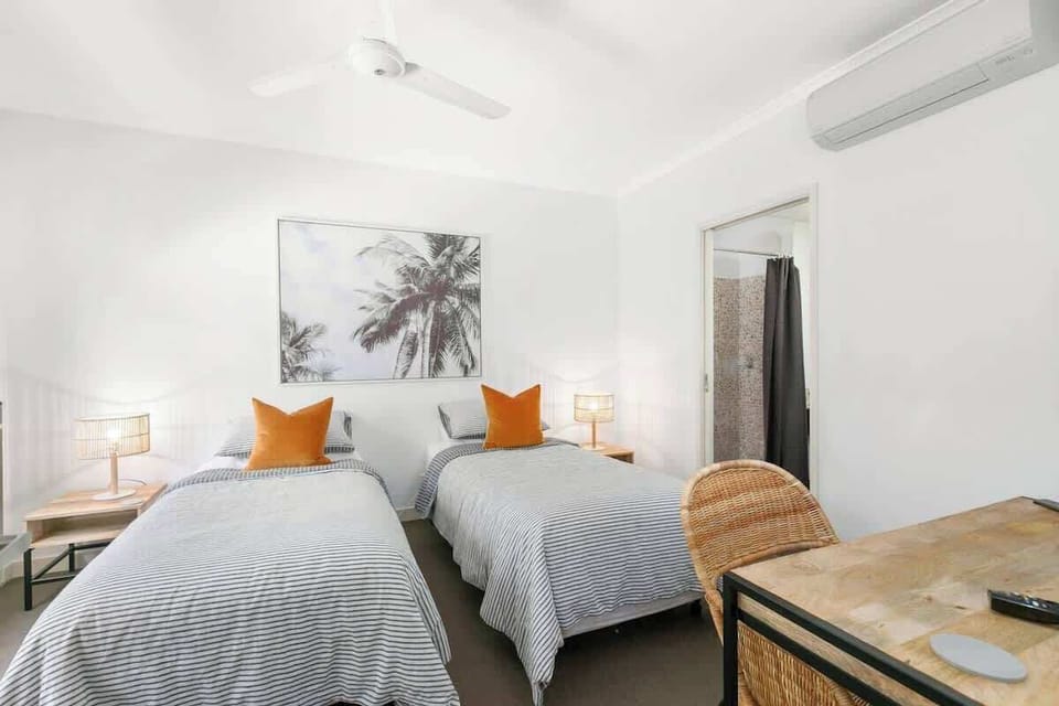 Room two has two single beds, which can be joined together to create a queen. There is a dedicated workspace and ensuite bathroom. 
