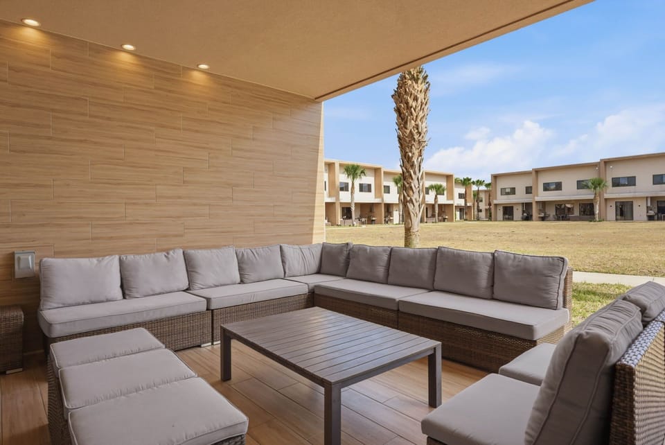 Outdoor patio with seating area and barbecue grill