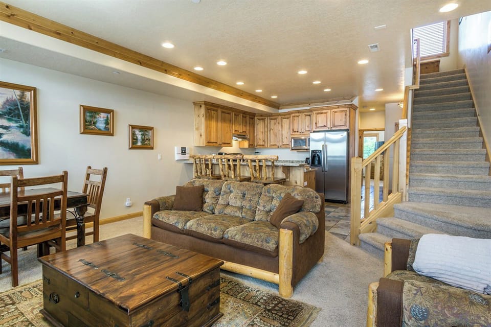 An open-concept living and dining area designed for gathering, featuring rustic elegance, comfortable seating, and seamless flow throughout the home.