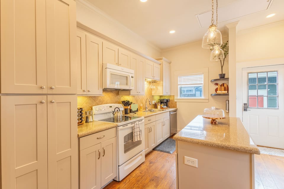 Modern kitchen thoughtfully stocked with essentials. 