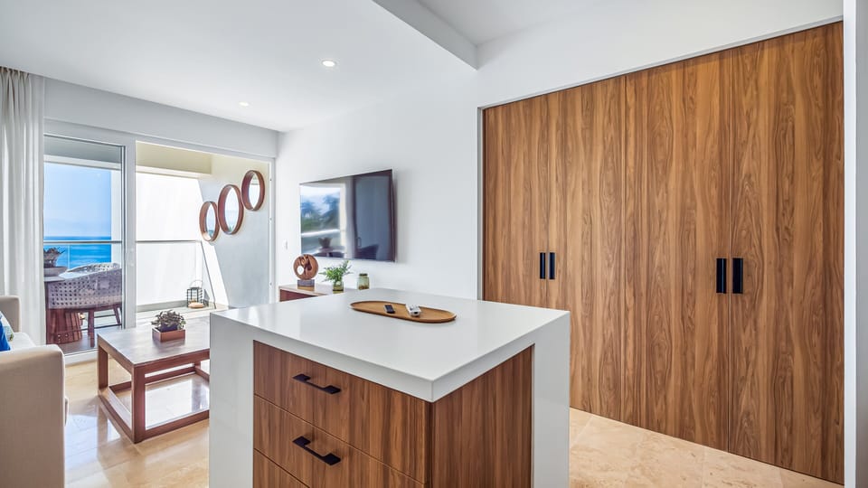 Inviting dining area integrated into the living space, ideal for shared meals with natural light and ocean views nearby.