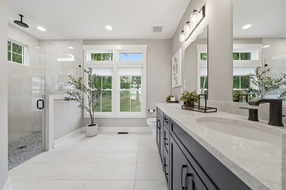 Luxurious Spa Bathroom: Indulge in modern elegance with sunlit views and serene greenery outside!