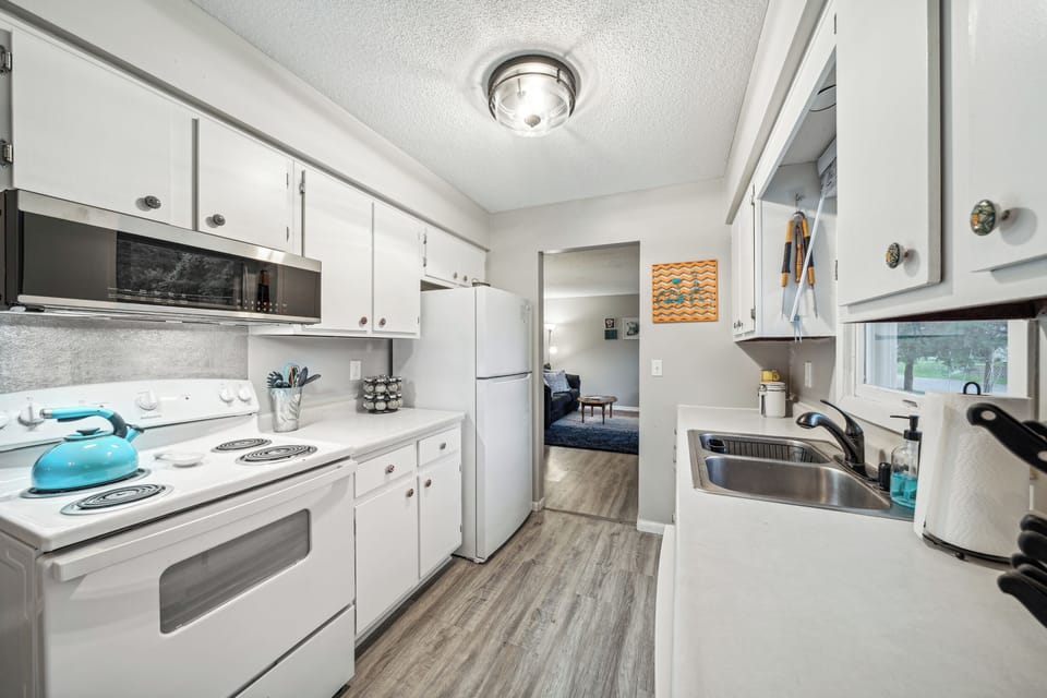 The galley kitchen connects the living room and dining area.
