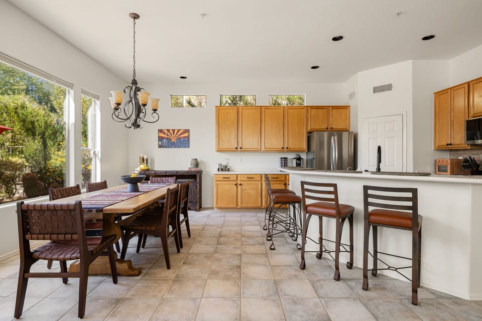 Gather and dine in this bright, open kitchen and dining area featuring ample seating, natural light, and a seamless flow for easy entertaining.